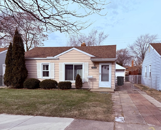 view of front of house featuring a garage and a front yard