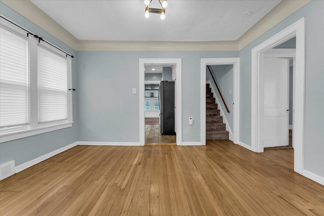 spare room with light hardwood / wood-style floors