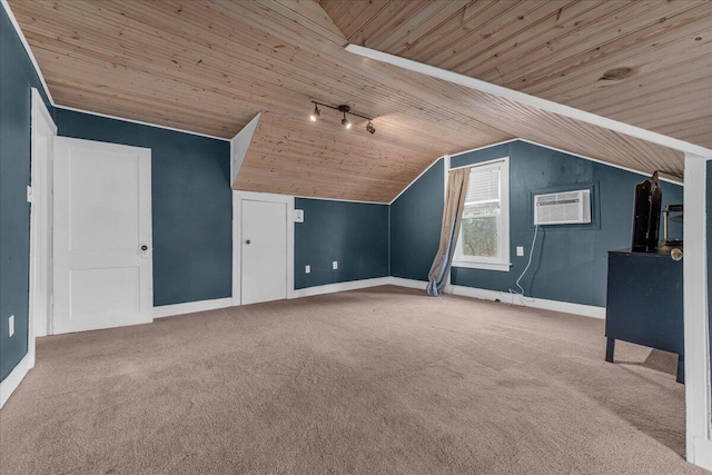 additional living space with lofted ceiling, wood ceiling, a wall mounted AC, and carpet flooring