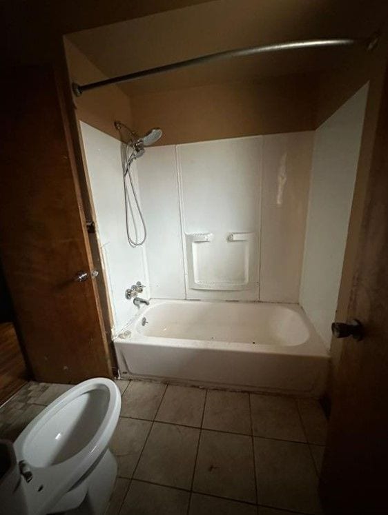 bathroom featuring tile patterned flooring and shower / bathing tub combination