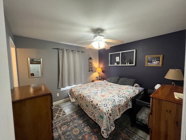 bedroom featuring hardwood / wood-style flooring and ceiling fan