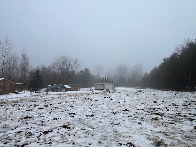 yard covered in snow featuring an outdoor structure