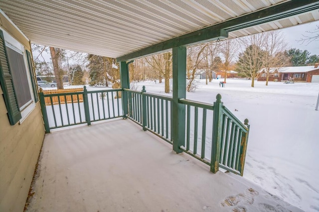 snow covered patio with a porch
