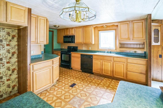 kitchen with a notable chandelier, sink, hanging light fixtures, and black appliances