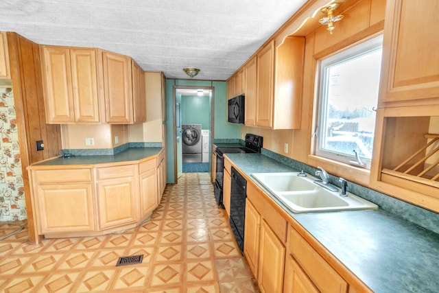 kitchen with sink, light brown cabinetry, independent washer and dryer, and black appliances