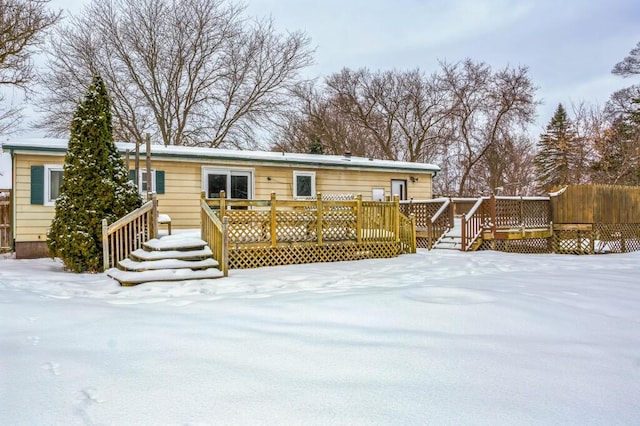 snow covered property with a deck