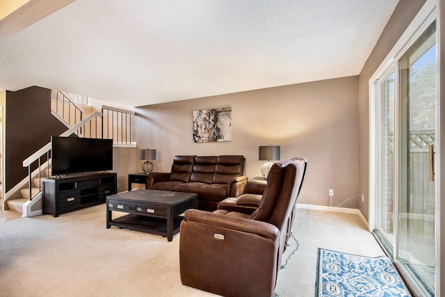 carpeted living room with a textured ceiling