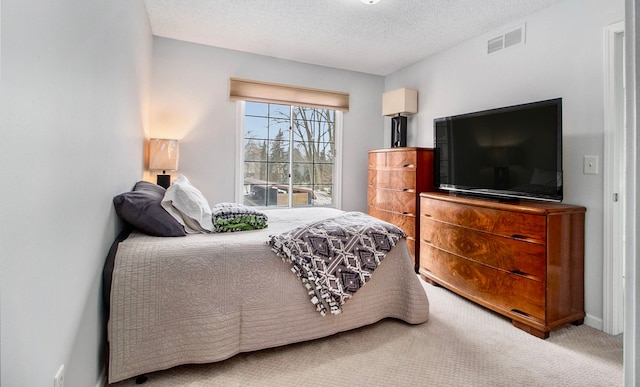 bedroom featuring carpet floors and a textured ceiling