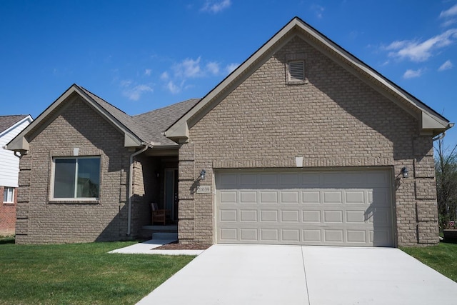 view of front of property with a garage and a front yard