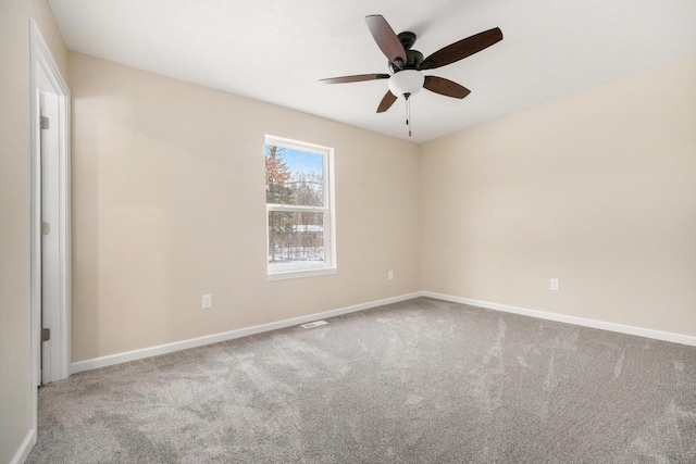 spare room featuring carpet floors and ceiling fan