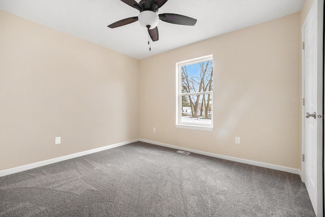 spare room with ceiling fan and carpet floors