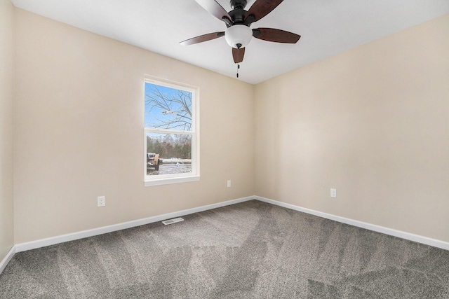 carpeted spare room featuring ceiling fan