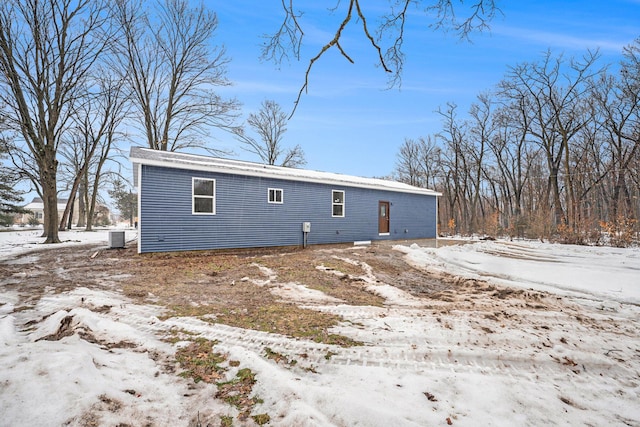 snow covered house with central AC