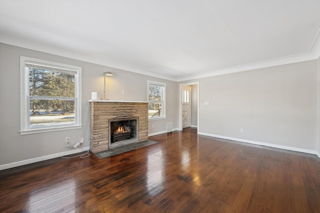 unfurnished living room with crown molding, a fireplace, and dark hardwood / wood-style flooring