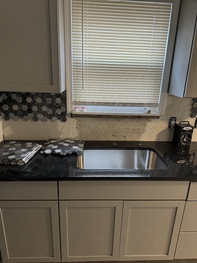 kitchen featuring tasteful backsplash and dark stone countertops