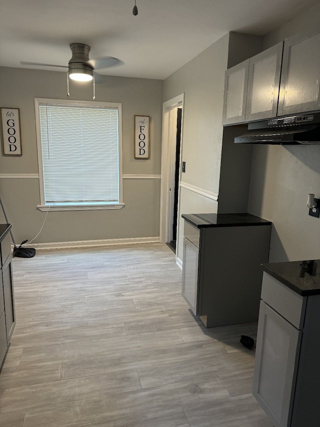 kitchen with gray cabinetry, light hardwood / wood-style floors, and ceiling fan