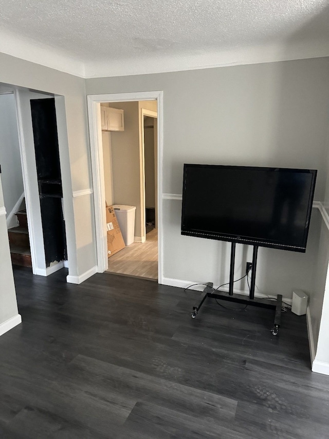 interior space with dark hardwood / wood-style flooring and a textured ceiling