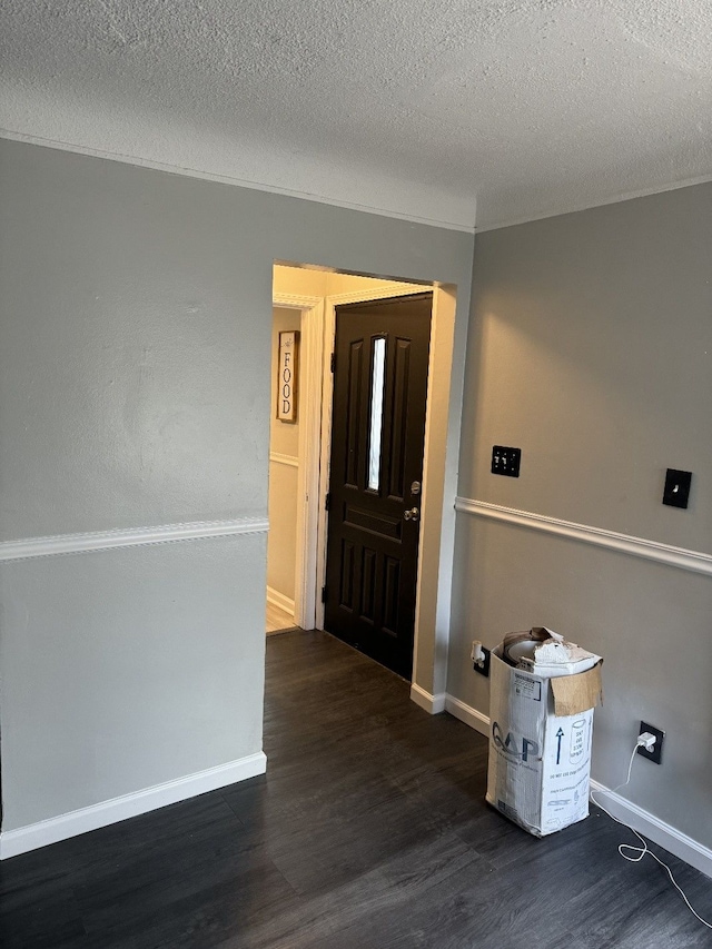 foyer featuring dark hardwood / wood-style floors and a textured ceiling