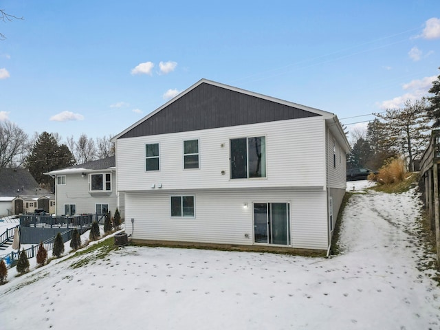 snow covered property featuring central AC unit