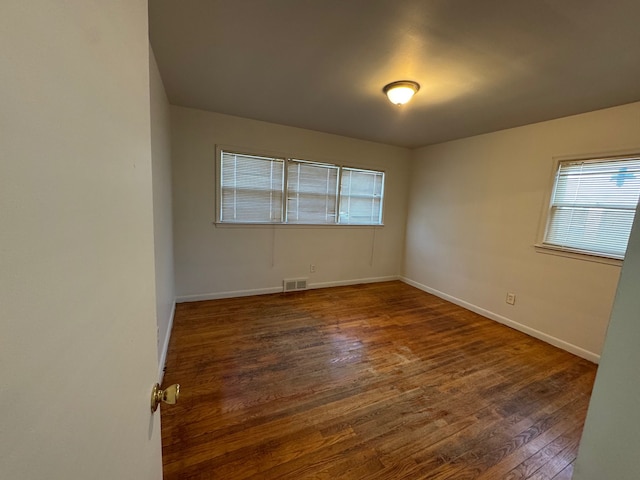 empty room featuring dark wood-type flooring