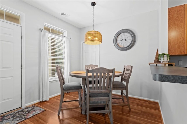 dining area with dark hardwood / wood-style floors