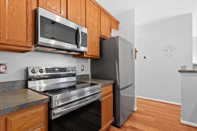 kitchen with stainless steel appliances and light wood-type flooring