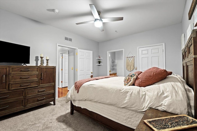 bedroom with ensuite bath and ceiling fan