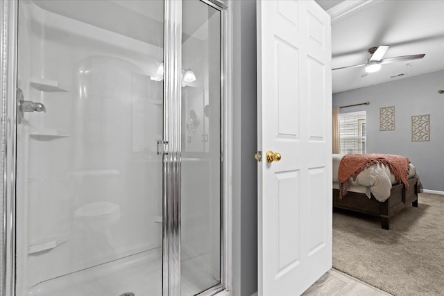 bathroom with ceiling fan and a shower with shower door