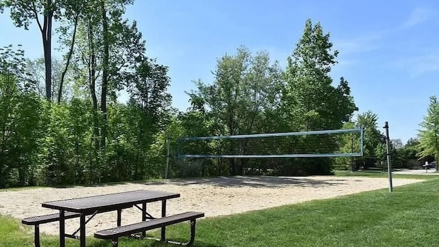 view of home's community featuring a lawn and volleyball court