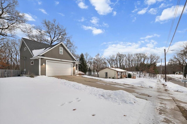 view of snow covered exterior with a garage