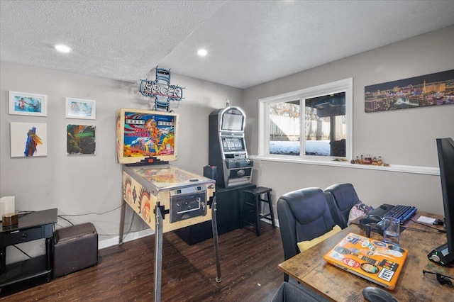 home office with dark wood-type flooring and a textured ceiling