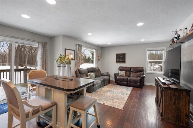 living room with dark hardwood / wood-style floors and a textured ceiling