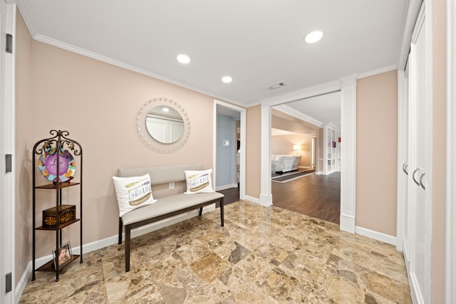 hallway featuring ornamental molding and ornate columns