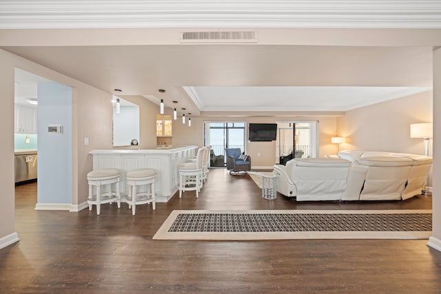 living room featuring crown molding and dark wood-type flooring