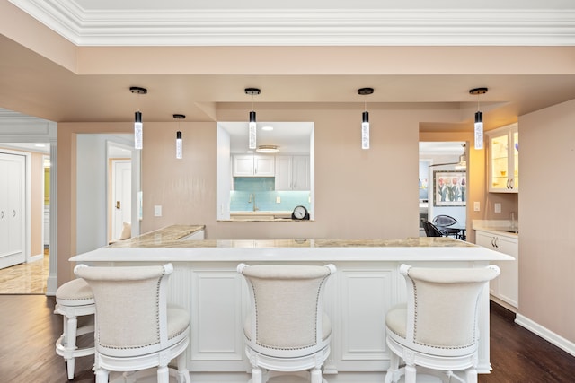 kitchen featuring white cabinetry, dark hardwood / wood-style floors, and hanging light fixtures