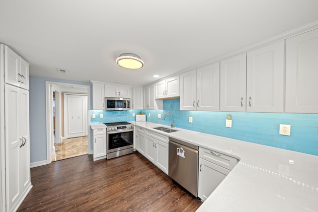 kitchen featuring white cabinetry, appliances with stainless steel finishes, and sink