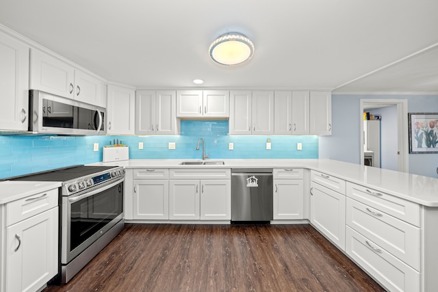 kitchen with white cabinetry, sink, kitchen peninsula, and appliances with stainless steel finishes