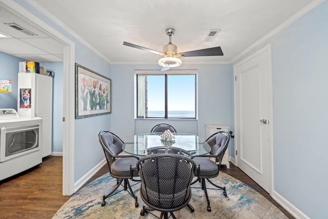 dining space featuring washer / clothes dryer, ornamental molding, ceiling fan, and dark hardwood / wood-style flooring