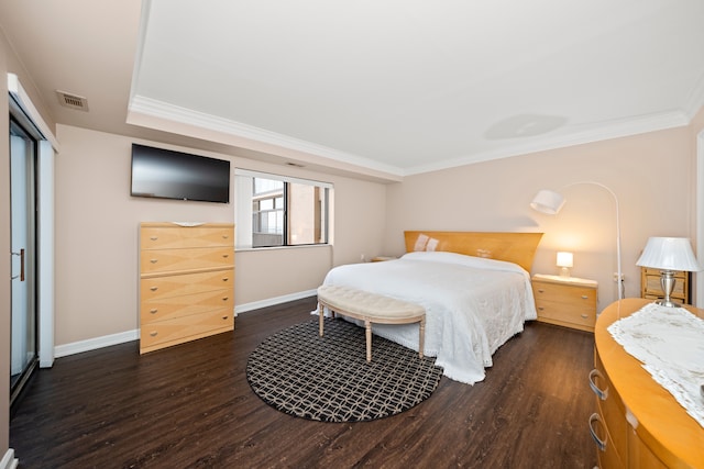 bedroom with dark hardwood / wood-style flooring and crown molding