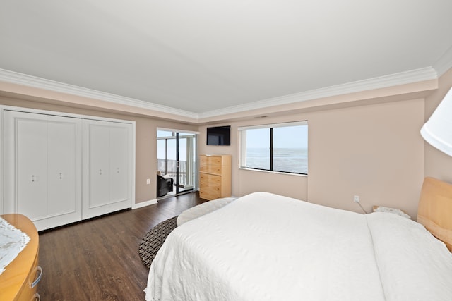 bedroom featuring a water view, ornamental molding, and dark hardwood / wood-style floors