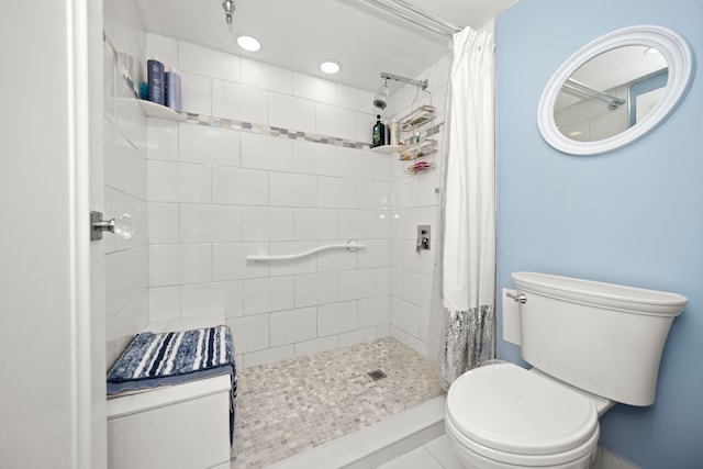 bathroom with a shower with curtain and toilet