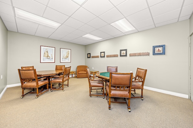 dining area with carpet flooring and a drop ceiling