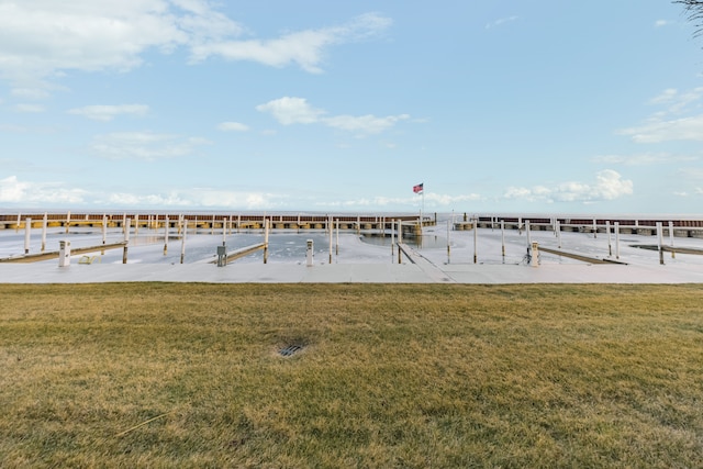 view of dock featuring a lawn