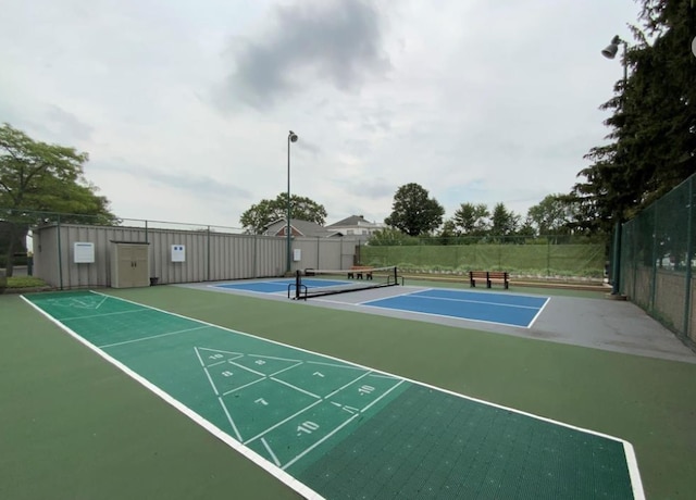 view of community with tennis court