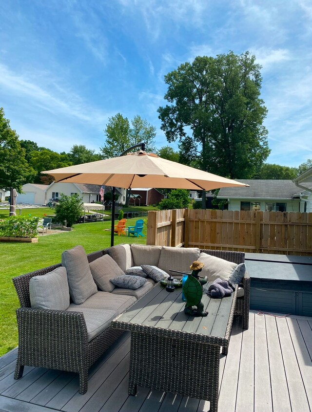 wooden deck with a yard and an outdoor living space