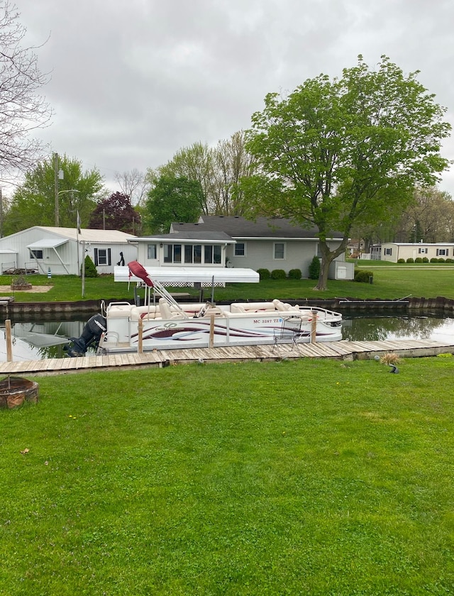 exterior space featuring a lawn and a water view