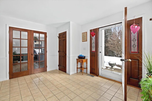 entryway featuring french doors, visible vents, and light tile patterned floors