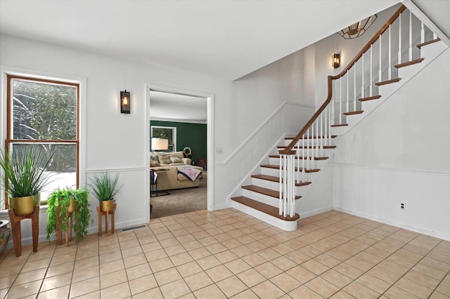 stairs featuring tile patterned floors and visible vents