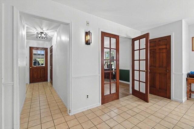 foyer entrance featuring light tile patterned floors and french doors