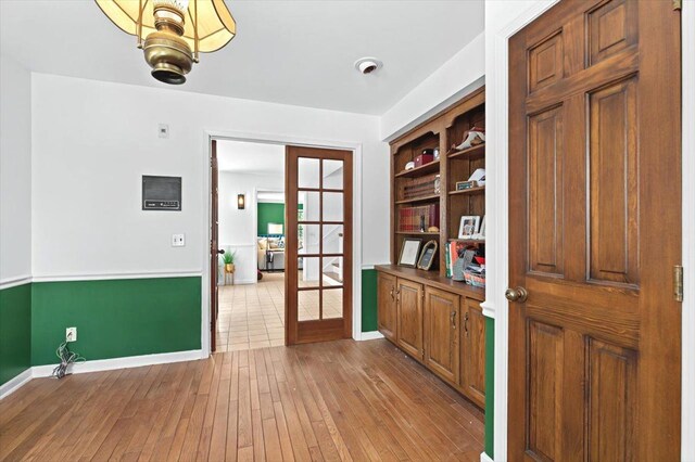 interior space with light wood-type flooring and french doors